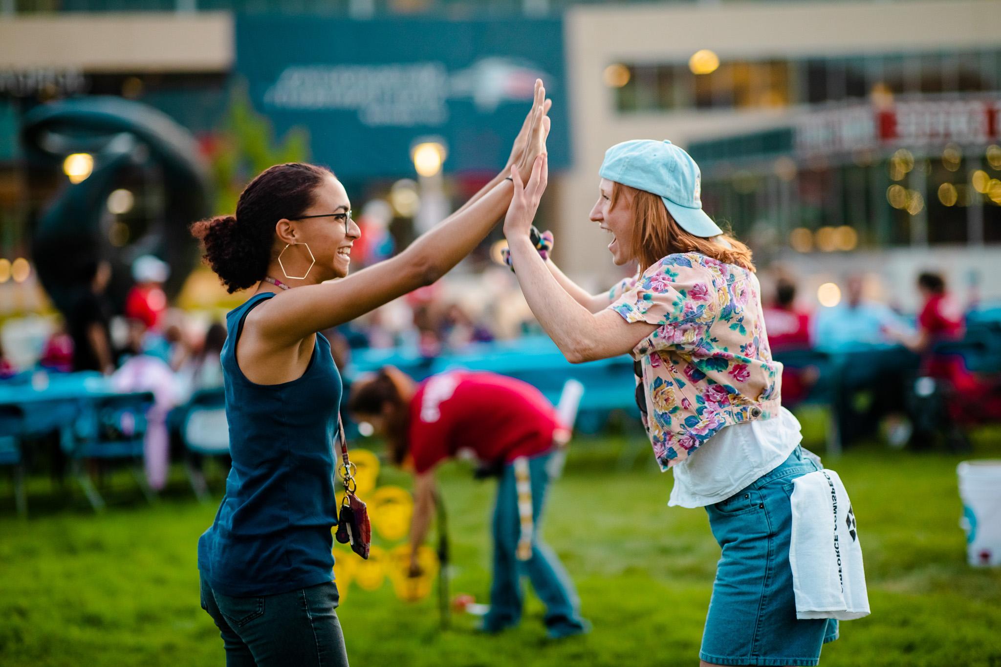 Two participants having a double high five during a challenge