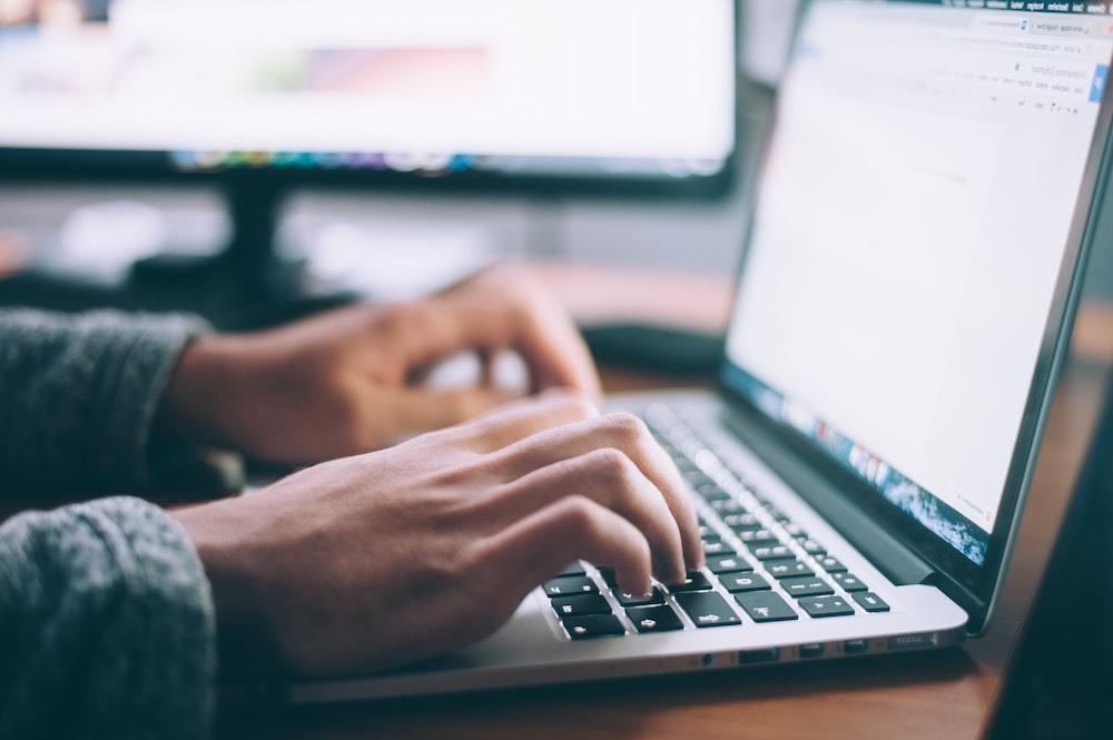 Person typing on a laptop