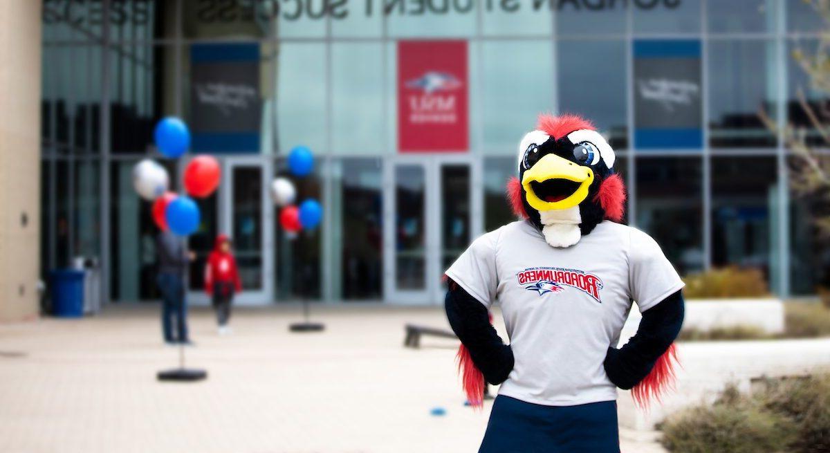 Rowdy stands confidently in front of the Jordan Student Success Building