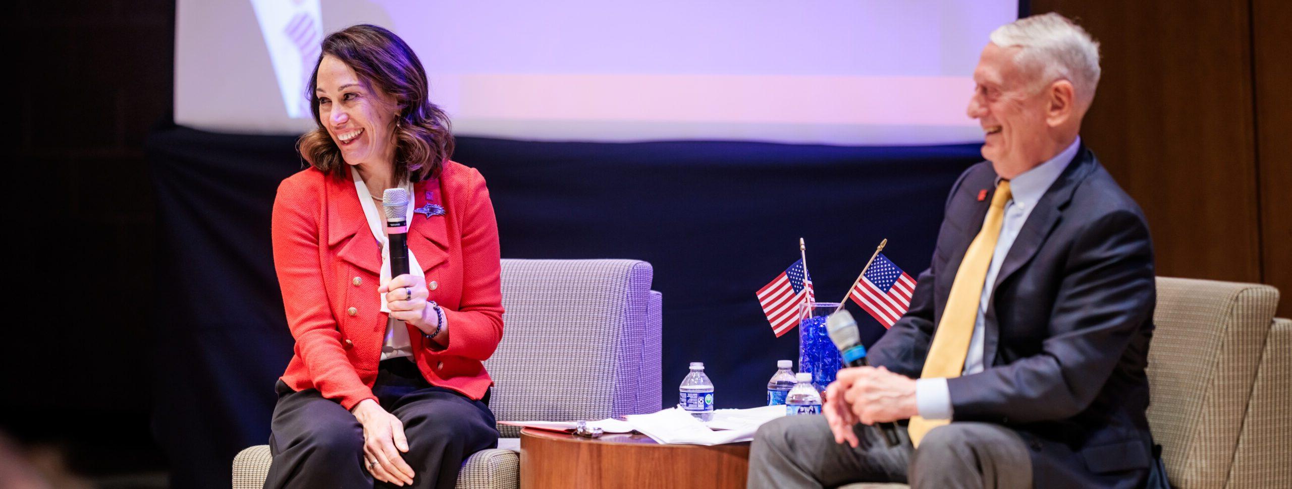 President Janine Davidson, Ph.D., speaks on stage with Gen. Jim Mattis USMC Ret.