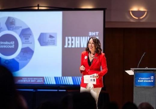 President Davidson stands in front of a PowerPoint slide containing an image of 